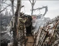  ?? ?? Boghdan, a Ukrainian soldier with the 79th Air Assault Brigade, fires a rocket-propelled grenade toward Russian forces from a trench in an area of Marinka. He was trying to stop the Russians from digging in. After some return gunfire, there was silence.