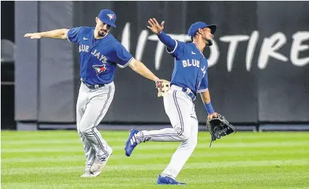  ?? WENDELL CRUZ • USA TODAY SPORTS ?? Toronto Blue Jays outfielder­s Randal Grichuk, left, and Jarrod Dyson (1) celebrate after defeating the New York Yankees at Yankee Stadium on Thursday night.