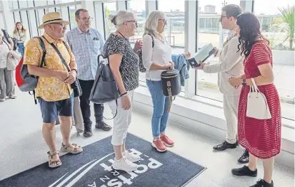  ?? ?? The first passenger at the new terminal was handed a memento by the city’s mayor and mayoress