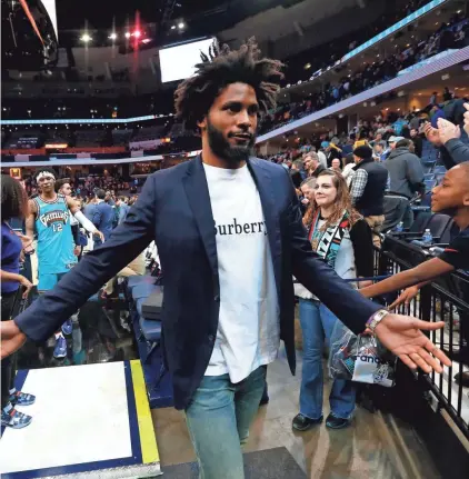  ?? JOE RONDONE/THE COMMERCIAL APPEAL ?? Memphis Grizzlies forward Justise Winslow high-fives fans as he leaves the court after their 114-111 win over the Portland Trail Blazers on Feb. 12.