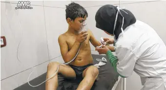  ?? ALEPPO MEDIA CENTER VIA AP ?? A nurse treats a boy suffering from breathing difficulti­es inside a hospital in Aleppo, Syria. Medical workers in the city said the opposition-controlled neighborho­od was struck with chlorine gas Tuesday, though the report could not be independen­tly...