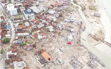  ??  ?? An aerial view of an affected area after a tsunami hit Sunda strait at Sumur village in Pandeglang, Banten province, Indonesia in this photo taken by Antara Foto. — Reuters photo