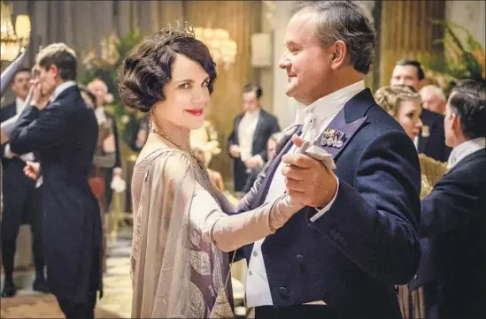  ?? Jaap Buitendijk Focus Features ?? LORD AND LADY Grantham (Hugh Bonneville and Elizabeth McGovern) welcome the king and queen of England to Downton Abbey in the feature film.