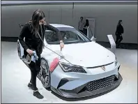  ?? Bloomberg/KRISZTIAN BOCSI ?? An employee dusts a Seat Cupra e-Racer electric sports car during Volkswagen AG’s annual general meeting in Berlin last week.