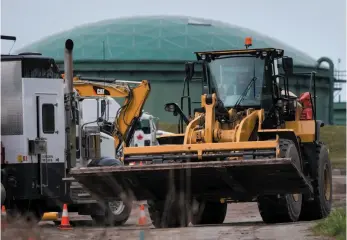  ?? CP FILE PHOTO ?? A worker uses heavy equipment to move a wood platform at Kinder Morgan’s facility in Burnaby on April 9, in preparatio­n for the expansion of the Trans Mountain pipeline.