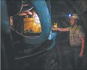  ??  ?? A Bosnian coal miner works in an undergroun­d tunnel.