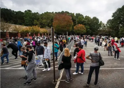  ?? Photograph: Ron Harris/AP ?? Hundreds of people wait in line for early voting on Monday, in Marietta, Georgia.