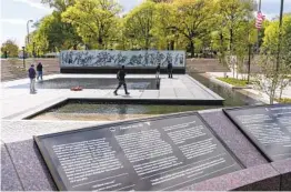  ?? JACQUELYN MARTIN AP ?? People visit the newly opened World War I Memorial on Friday at Pershing Park in Washington.