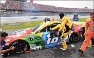  ?? John Amis / Associated Press ?? Kyle Busch gets in his car for a NASCAR Cup race on Sunday in Talladega, Ala. The race was postponed until Monday due to wet weather during a pace lap.