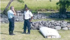  ?? — AFP ?? File photo taken on July 29, 2015 shows a policeman and a gendarme standing next to a piece of debris identified to be from MH370, on the French Indian Ocean island of La Reunion.