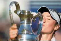  ?? AP-Yonhap ?? Nelly Korda kisses the trophy after winning the Chevron Championsh­ip LPGA golf tournament at The Club at Carlton Woods in The Woodlands, Texas, Sunday.