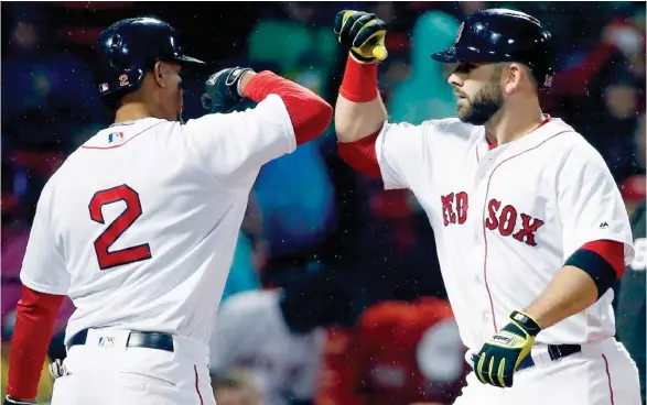  ?? (Photo by Michael Dwyer, AP) ?? Boston Red Sox's and former Mississipp­i State player Mitch Moreland, right, celebrates his solo home run with Xander Bogaerts during the second inning of Monday's game against the Kansas City Royals.