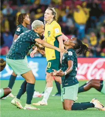  ?? TERTIUS PICKARD/AP ?? Nigeria’s Onome Ebi, left, and Osinachi Ohale celebrate at the end of the Women’s World Cup Group B match against Australia on Thursday.