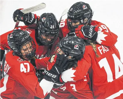  ?? DEREK LEUNG GETTY IMAGES ?? Jamie Rattray, left, celebrates with her Canadian teammates after scoring against Finland on Friday in Calgary.