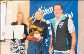  ?? PICTURE / KIRSTY SAXON. ?? Kelly Troughton was presented with several trophies (both as an individual and a member of one of the local teams competing in the 2019 nationals) by Robbie and Lynda Matthews at the Ahipara Gamefish Club prizegivin­g earlier this month.