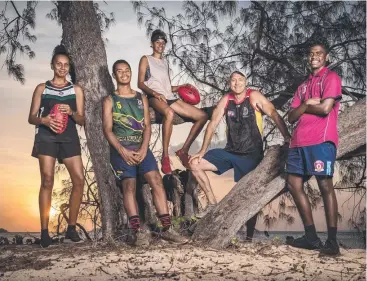  ??  ?? TEACHING EACH OTHER: AFL Cape York regional manager Rick Hanlon with young footy stars Caleece Bosuen, 17, Alwyn Bond, 14, Shannon Shaun, 14 and Tiarna Ahwang, 17. Picture: JAKE NOWAKOWSKI