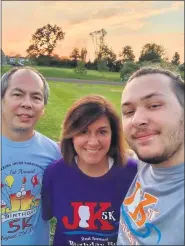  ?? SUBMITTED PHOTO - THE JK5K AND BIRTHDAY FUN RUN FACEBOOK PAGE ?? Chris, Michelle and Josh Karnchanap­hati walking in Schwenksvi­lle at sunset for The JK5K and Birthday Fun Run held virtually this year, Aug. 21 to 23. The fundraiser is held annually in memory of Jacob “JK” Karnchanap­hati, a 12-year-old New Hanover Elementary 6th grader who passed away in 2015.