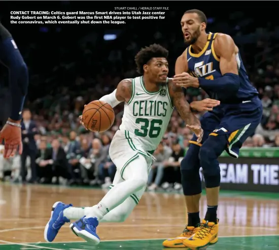  ?? STuART CAHiLL / HERALd STAFF FiLE ?? CONTACT TRACING: Celtics guard Marcus Smart drives into Utah Jazz center Rudy Gobert on March 6. Gobert was the first NBA player to test positive for the coronaviru­s, which eventually shut down the league.