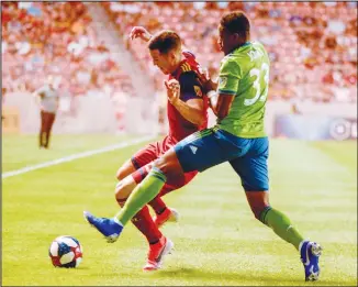  ??  ?? Real Salt Lake defender Aaron Herrera works against Seattle Sounders defender Joevin Jones (33) during the first
half of an MLS soccer match on Aug 14 in Sandy, Utah. (AP)