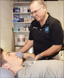  ?? Special to The Herald ?? Penticton Vees trainer Dan McDowell checks the shoulder of Vees forward Massimo Rizzo. The BCHL team often takes players to Penticton Regional Hospital’s Emergency department when injuries occur.