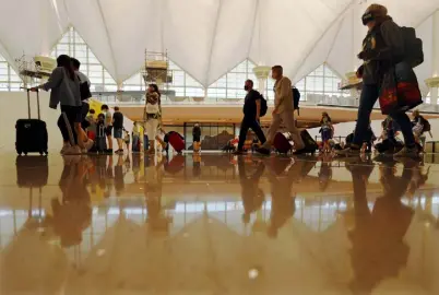  ?? Photos by Hyoung Chang, The Denver Post ?? Travelers arrive at the main concourse at Denver Internatio­nal Airport on July 7.