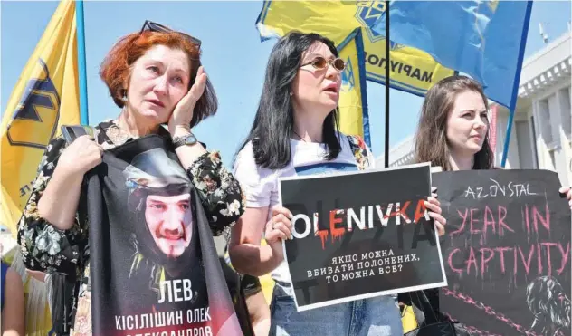  ?? Agence France-presse ?? ↑
Wives and relatives of captured Ukrainian servicemen hold placards during a rally in Kyiv on Saturday.