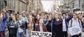  ?? Associated Press ?? Activist Greta Thunberg, center, in a scene from the documentar­y “I Am Greta,” the story of Thunberg, the teenage Swedish schoolgirl who is leading the global school strike for action on climate change.