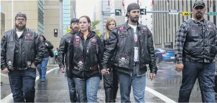  ?? CRYSTAL SCHICK/ CALGARY HERALD ?? Kyla Woodhouse, centre, and Brian Woodhouse, leave the courthouse with the Bikers Against Child Abuse after hearing the second- degree murder guilty verdict in the Meika Jordan murder trial in Calgary on Wednesday. Kyla Woodhouse is the child’s mother.