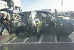  ?? Helen H. Richardson, The Denver Post ?? Joe Cross, value creation director, far left, and Ashley Phoenix, value creation manager, check out a new Kia Telluride this month at the i25 Kia dealership in Longmont.