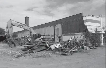  ?? Photos by Joseph B. Nadeau/The Call ?? Demolition is underway at the old car barn at the corner of Social Street and Diamond Hill Road. The long brick building was constructe­d for the Woonsocket Street Railroad Co. that operated electric street cars to carry workers to their jobs in local...