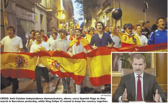  ?? AP PHOTOS ?? CRISIS: Anti-Catalan independen­ce demonstrat­ors, above, carry Spanish flags as they march in Barcelona yesterday, while King Felipe VI vowed to keep the country together.