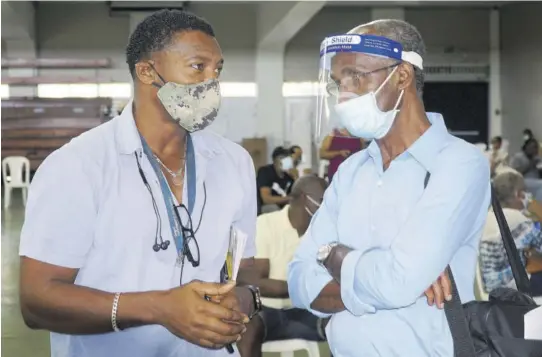  ?? (Photo: Dwayne Richards) ?? Donald Quarrie (right) speaking with Jamaica Athletics Administra­tive Associatio­n member Dr Lincoln Cox at the elections held at the National Arena in Kingston, last Saturday.