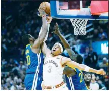  ?? ?? San Antonio Spurs forward Keldon Johnson (3), Golden State Warriors forward Jonathan Kuminga, left, and center Draymond Green, right, compete for possession of the ball during the second half of an NBA basketball game Saturday, March 9, 2024, in San Francisco. (AP)