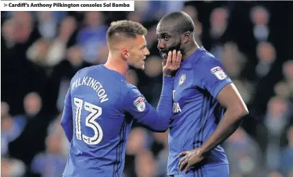  ??  ?? > Cardiff’s Anthony Pilkington consoles Sol Bamba