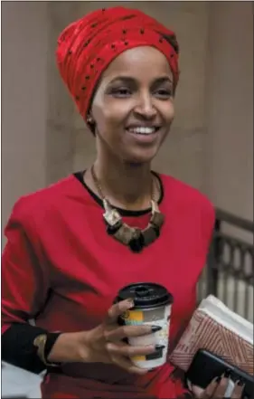  ?? ASSOCIATED PRESS ?? In this Jan. 16 photo, Rep. Ilhan Omar, D-Minn., center, walks through the halls of the Capitol Building in Washington. Her statements have caused a furor and brought accusation­s of anti-Semitism.