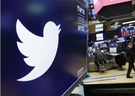  ?? AP FILE ?? CHARACTER ISSUE: The Twitter logo is displayed above a trading post on the floor of the New York Stock Exchange. The company offered details Friday on its ban on political ads.