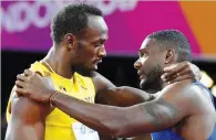  ??  ?? Usain Bolt (L) embraces Justin Gatlin after their race on Saturday in London