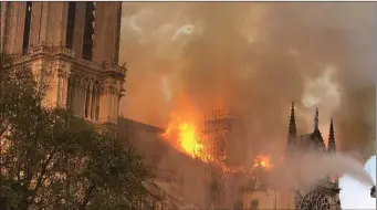  ??  ?? Fire rips through the Notre Dame cathedral in the heart of Paris on Monday evening.