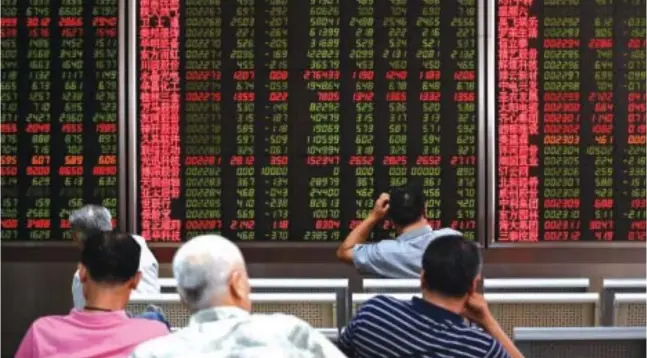  ?? AFP ?? Investors sit on chairs as they watch stock market movements displayed on screens at a securities company in Beijing in this file photo taken on Aug. 26.