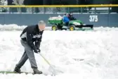  ?? JACK DEMPSEY/ THE ASSOCIATED PRESS ?? Colorado Rockies execs like chief baseball officer Dan O’Dowd shovelled before Tuesday’s game.