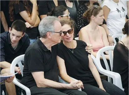  ?? (Roy Alima/Flash90) ?? IRIS AND AVI Nesher mourn on Sunday during the funeral of their son, Ari Nesher, in Moshav Udim cemetery.