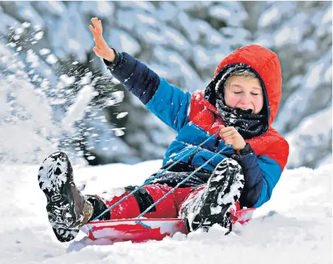  ??  ?? Eleven-year-old Alex has fun sledging through deep snow near Alston, Cumbria, yesterday morning ahead of snowfall which is expected to hit much of the rest of the country