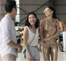  ??  ?? Henry Golding, Constance Wu, centre, and Sonoya Mizuno star in Crazy Rich Asians, based on the bestsellin­g book by Kevin Kwan, who says the adaptation by director Jon Chu is “even better than I imagined.”