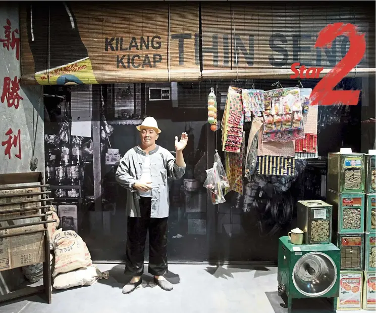  ?? — AZHAR MAHFOF/The Star ?? How much for a bag of biscuits? A shopkeeper mannequin welcomes visitors in front of a replica of an old Chinese sundry shop at the Malaysian Chinese Museum.