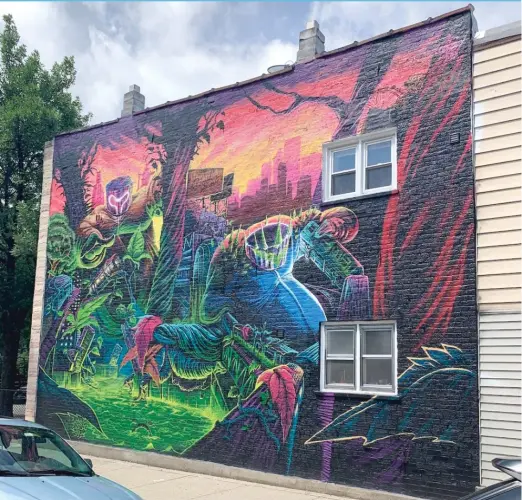  ?? ABOVE: ROBERT HERGUTH/SUN-TIMES; LEFT: PROVIDED PHOTO ?? Renaud Taelemans, who goes by “My Name is Ebo,” in front of the mural he completed to promote a Chicago show by the electronic dance duo Ganja White Night.