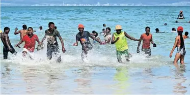  ?? AYANDA NDAMANE African News Agency (ANA) ?? YOUNGSTERS took advantage of the hot weather yesterday to enjoy the surf at Monwabisi Beach