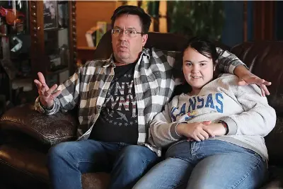  ?? (AP Photo/john Hanna) ?? Rick Elskamp sits with his oldest daughter, Sheridan, and discusses the frustratio­ns of having his 23-year-old daughter on a waiting list for 10 years for services as an intellectu­ally disabled adult o Jan. 27 at the Elskamps’ home outside Topeka, Kan. Thousands of Kansas residents with disabiliti­es and hundreds of thousands across the U.S. are on waiting lists for services.