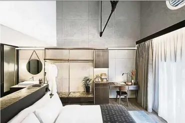  ??  ?? In the guestrooms of The Warehouse Hotel, the use of solid metallic materials such as brass, as well as the raw finishing of surfaces, take cues from the building’s industrial past. — DARREN SOH/The Warehouse Hotel