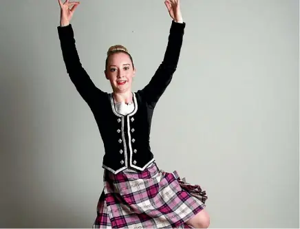  ??  ?? Highland dancer Kayla McQuoid is overjoyed with winning her trophy, which marks her ranking of fifth in the world.