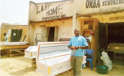  ??  ?? Daniel Ari, a leading coffin maker in front of his shop where his wares are on open display
